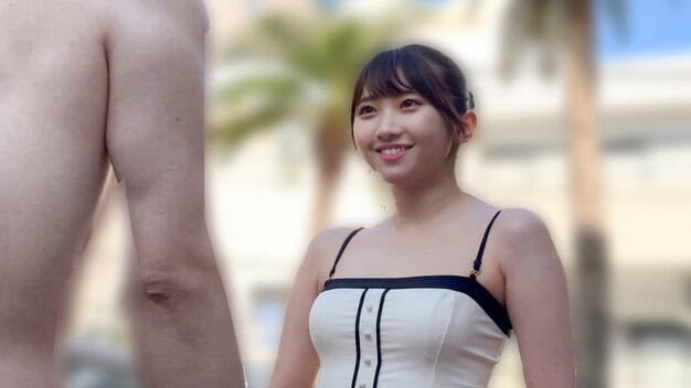 黒髪の女性が水着を着て笑い、隣に裸の男性が立っている。